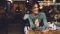 In the photo there's a woman holding a smartphone and smiling.